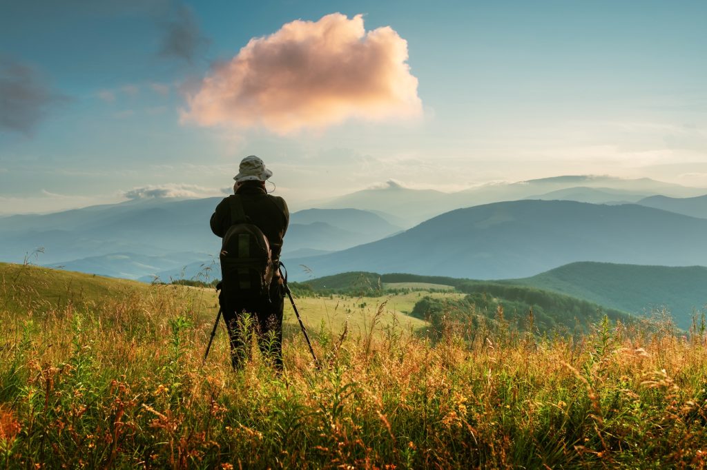 A silhouette of a photographer with a tripod